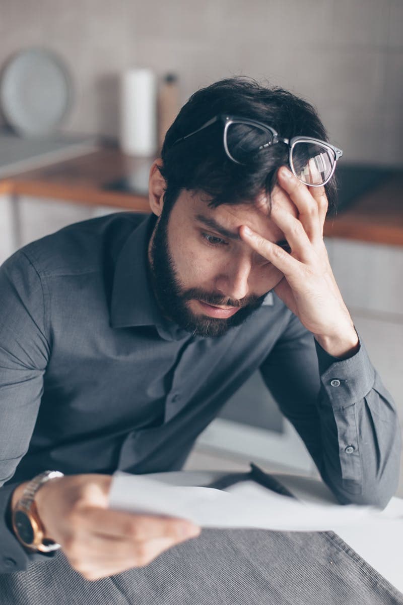 Person reading paperwork with concern