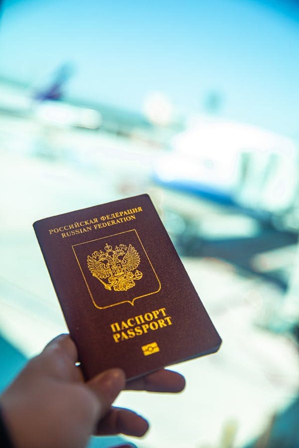 Passport held near an airport gate