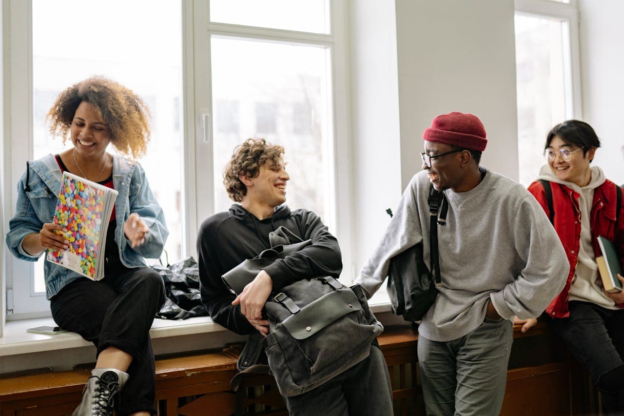 A cheerful and diverse group of students socializing in a well-lit indoor setting